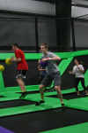 Two Boys and Two Girls Playing Trampoline Dodgeball on a Team